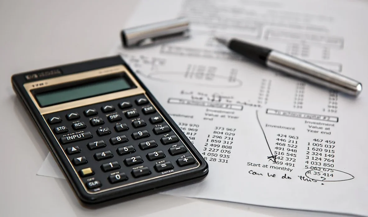 A black calculator on top of accounting documents